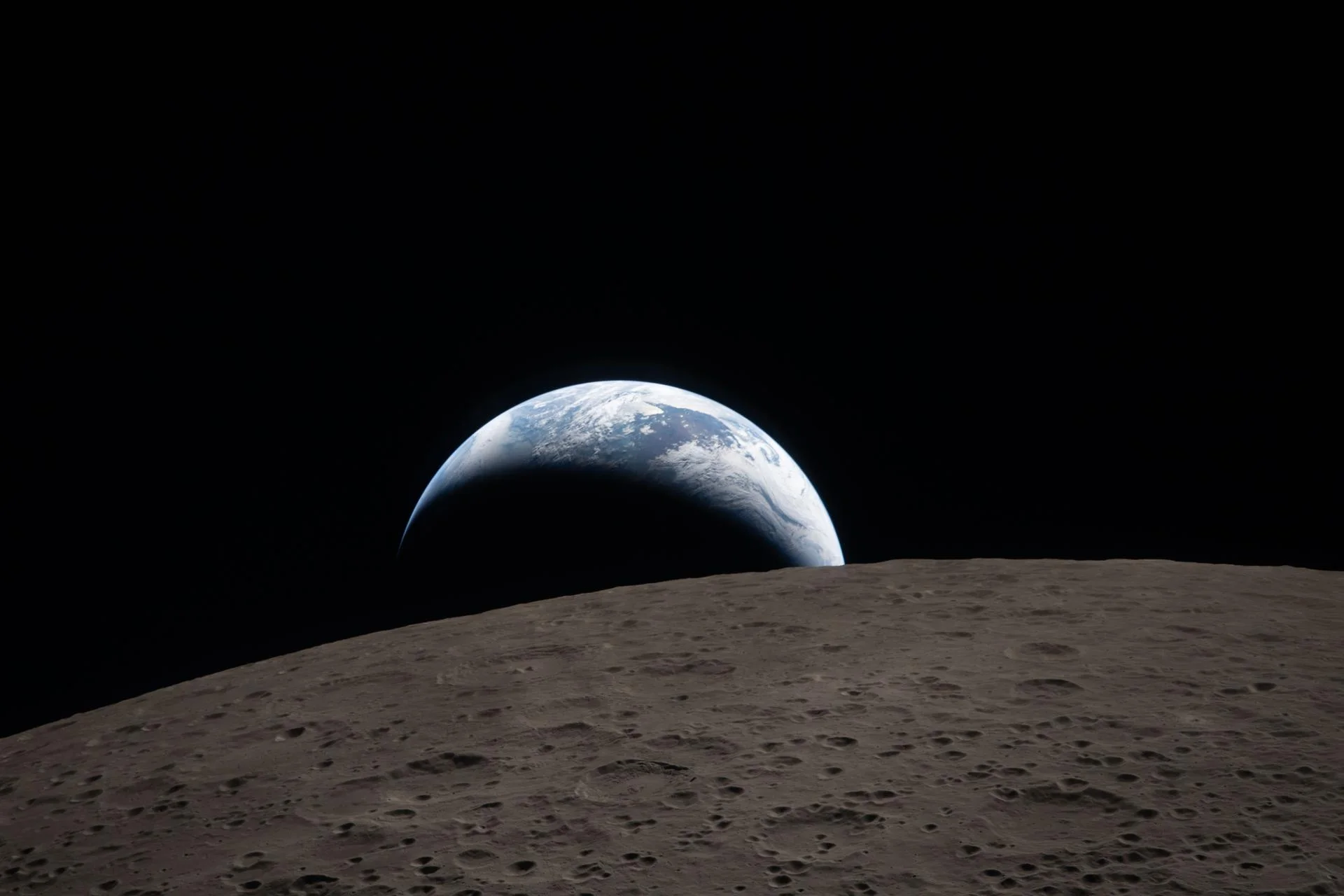 Earthset captured through the Orion spacecraft window as the crescent Earth sinks behind the Moon's far side during the Artemis II flyby